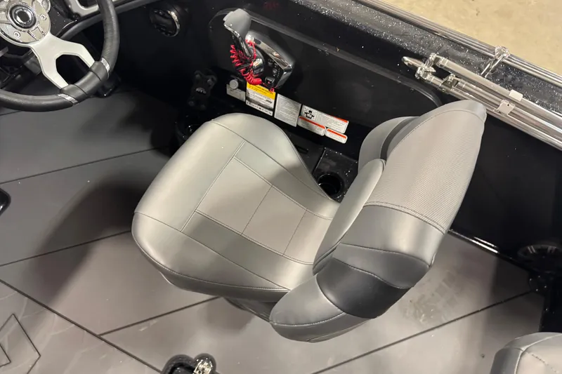 Slide: The Image of Interior of 2026 Nitro ZV19 Sport Pro boat with steering wheel and seat. - 19