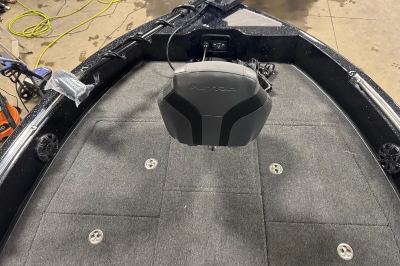 Slide: The Image of 2026 Nitro ZV19 Sport Pro boat interior with carpeted deck and mounted equipment. - 8