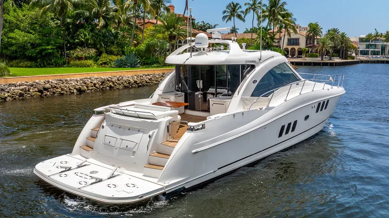 Slide: The Image of 2008 Sea Ray Sundancer yacht cruising on a scenic waterway with palm trees. - 6