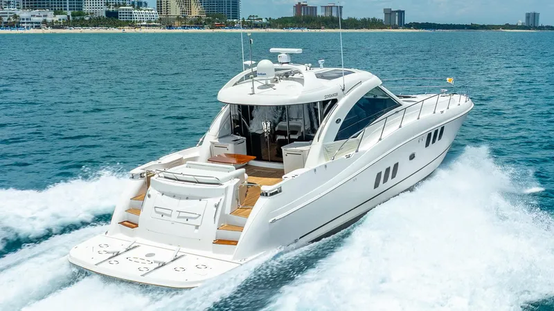 Slide: The Image of 2008 Sea Ray Sundancer yacht cruising on open water near a city skyline. - 3