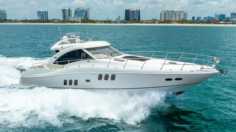 The Image of 2008 Sea Ray Sundancer yacht cruising on ocean near city skyline. - 1
