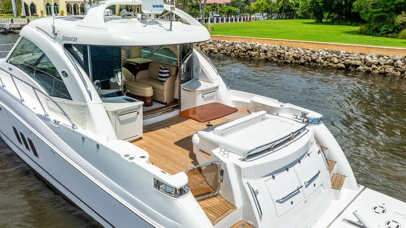 Slide: The Image of 2008 Sea Ray Sundancer yacht with open deck, docked by a scenic waterfront. - 35