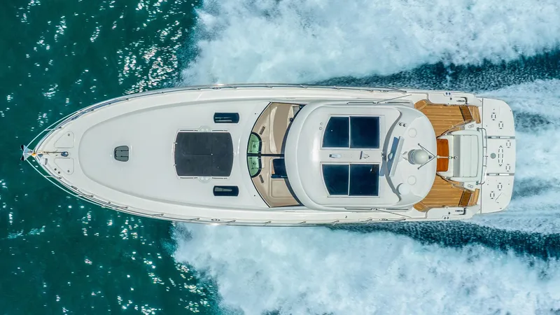 Slide: The Image of Aerial view of 2008 Sea Ray Sundancer yacht cruising on blue ocean waters. - 4