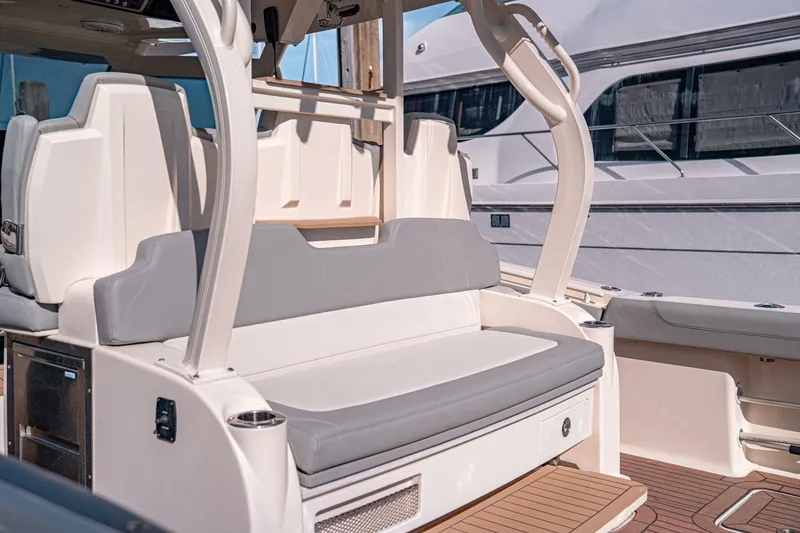 Slide: The Image of 2020 Scout 380 LXF boat interior with cushioned seating and sleek design. - 11
