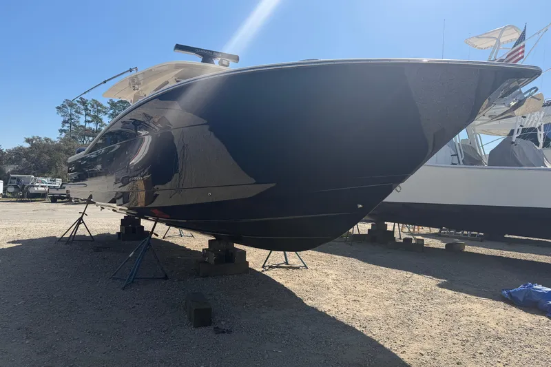 Slide: The Image of 2020 Scout 380 LXF boat on stands in a sunny outdoor setting. - 9