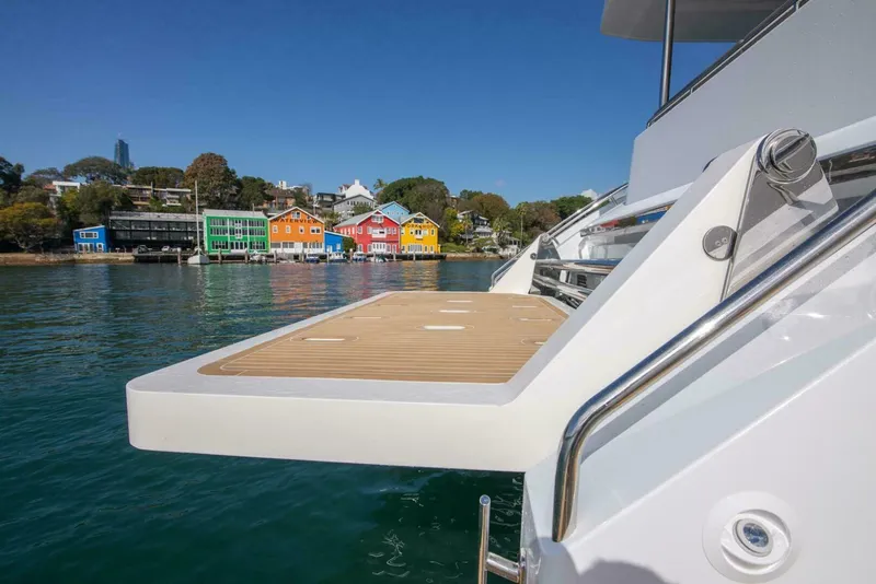 Slide: The Image of Luxury yacht ILIAD 53F, 2026 model, with colorful waterfront houses in the background. - 24