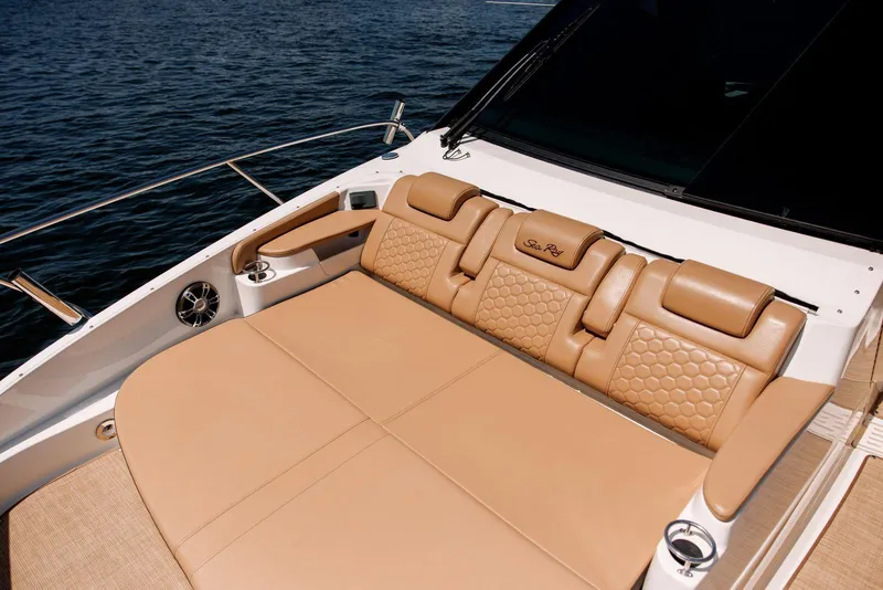 Slide: The Image of Luxurious seating on 2022 Sea Ray Sundancer 320 Outboard, featuring tan leather upholstery. - 7
