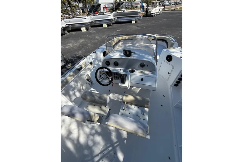 Slide: The Image of 2019 Hurricane SunDeck Sport CC 231 OB boat interior with steering console and seating. - 11