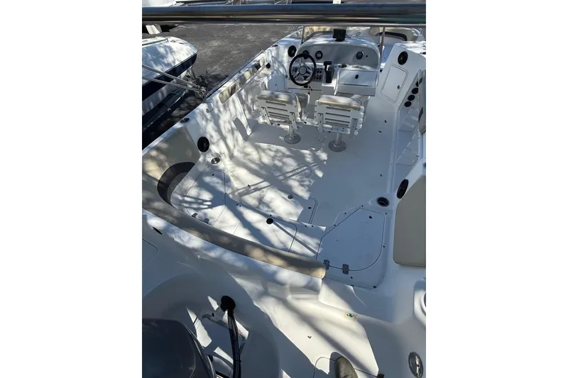 Slide: The Image of 2019 Hurricane SunDeck Sport CC 231 OB boat interior with dual helm seats and spacious deck. - 12