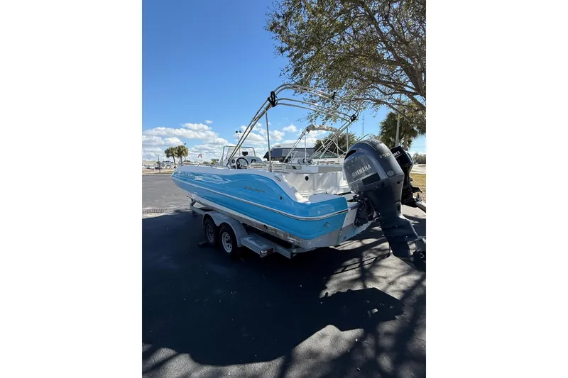 Slide: The Image of 2019 Hurricane SunDeck Sport CC 231 OB boat with Yamaha outboard motor, parked under a tree. - 3