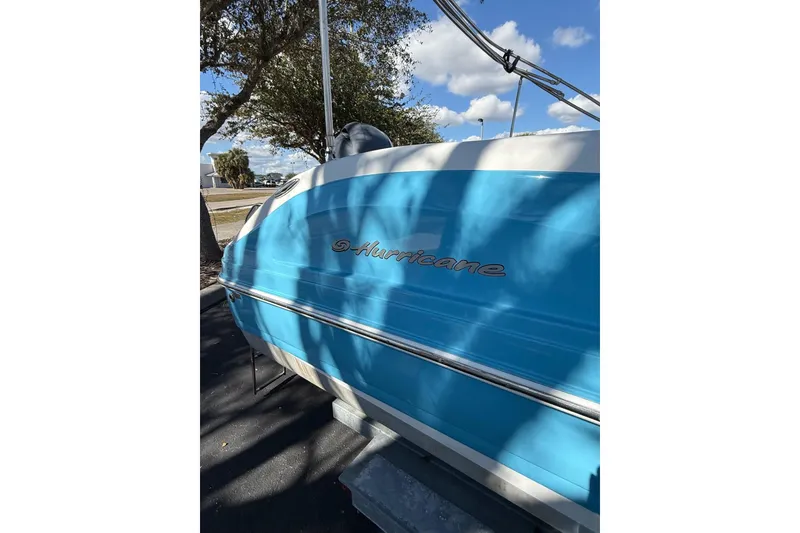 Slide: The Image of 2019 Hurricane SunDeck Sport CC 231 OB boat, blue exterior, parked outdoors. - 7