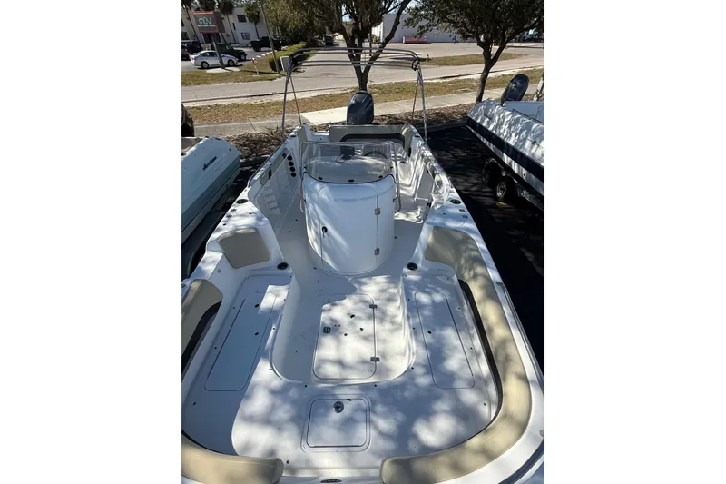 Slide: The Image of 2019 Hurricane SunDeck Sport CC 231 OB boat, spacious deck, sleek design, parked outdoors. - 9
