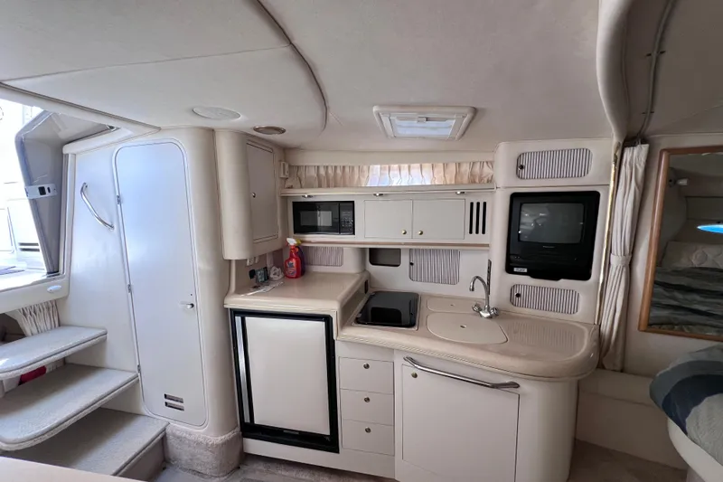 Slide: The Image of Interior of 2000 Sea Ray 340 Sundancer yacht with kitchenette and appliances. - 10