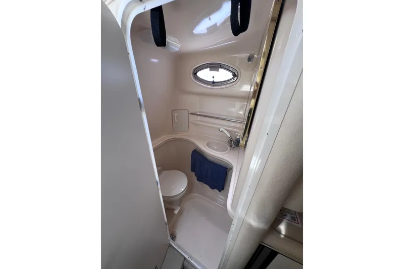Slide: The Image of Compact bathroom in 2000 Sea Ray 340 Sundancer yacht with sink and toilet. - 11