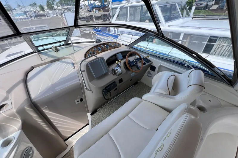Slide: The Image of Cockpit of 2000 Sea Ray 340 Sundancer with steering wheel and control panel. - 13