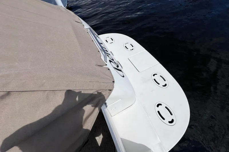 Slide: The Image of 2000 Sea Ray 340 Sundancer boat with beige cover and white swim platform. - 14