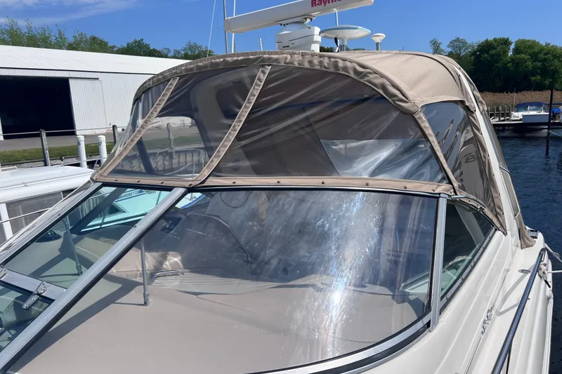 Slide: The Image of 2000 Sea Ray 340 Sundancer boat with beige canopy docked at marina. - 15