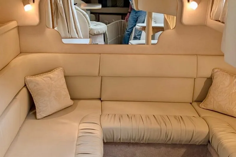 Slide: The Image of Interior of 2000 Sea Ray 340 Sundancer with beige seating and cushions. - 17