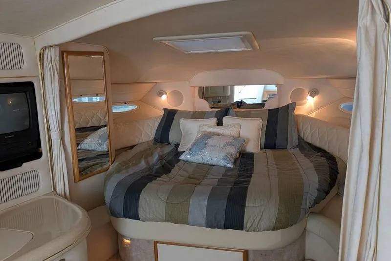 Slide: The Image of Luxurious cabin interior of 2000 Sea Ray 340 Sundancer yacht with cozy bed and ambient lighting. - 8