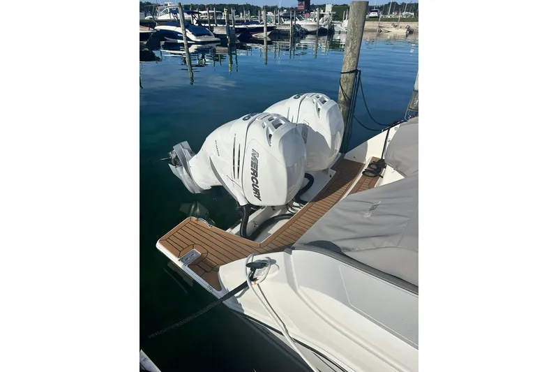 Slide: The Image of 2021 Tiara Yachts 34 LX with dual Mercury outboard engines docked at marina. - 3