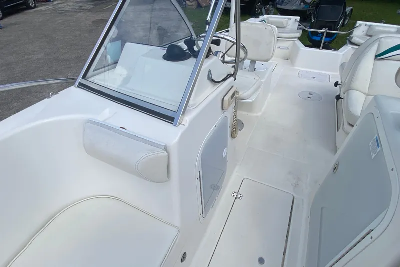 Slide: The Image of 2001 Aquasport 215 Osprey Sport boat interior with seating and steering console. - 12