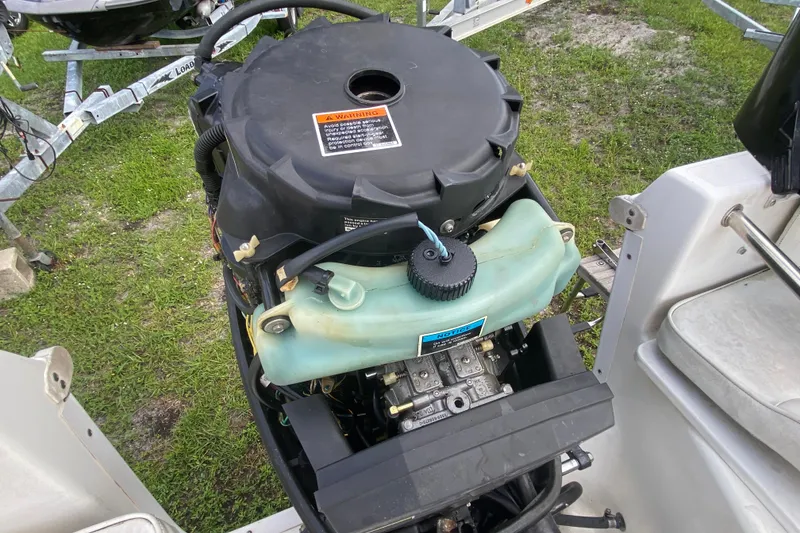 Slide: The Image of Engine of a 2001 Aquasport 215 Osprey Sport boat, showing detailed components. - 14