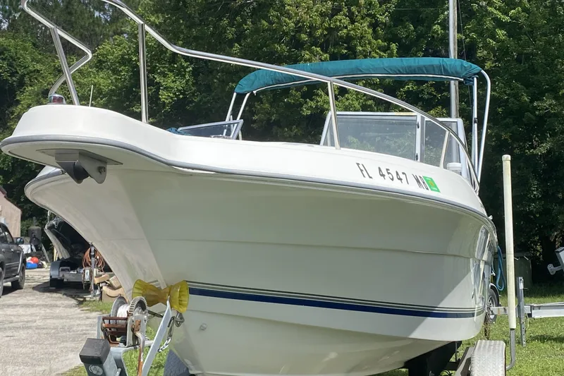 Slide: The Image of 2001 Aquasport 215 Osprey Sport boat on trailer, parked outdoors. - 3