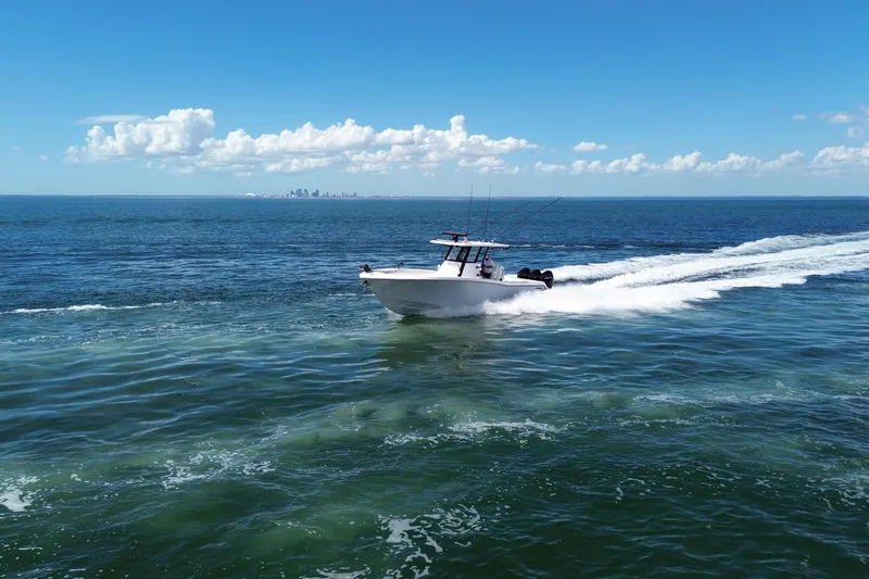 Slide: The Image of 2024 Invincible 36 Open Fisherman speeding on open ocean under clear blue sky. - 13