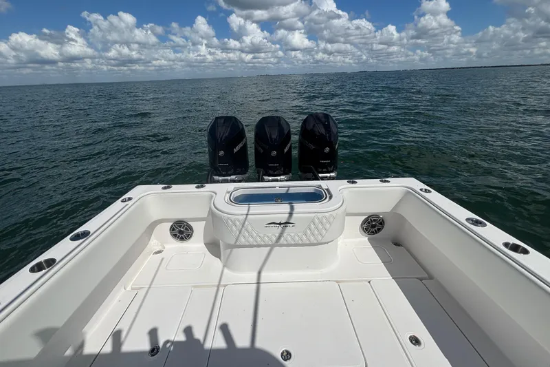 Slide: The Image of 2024 Invincible 36 Open Fisherman boat with triple Mercury engines on open water. - 15