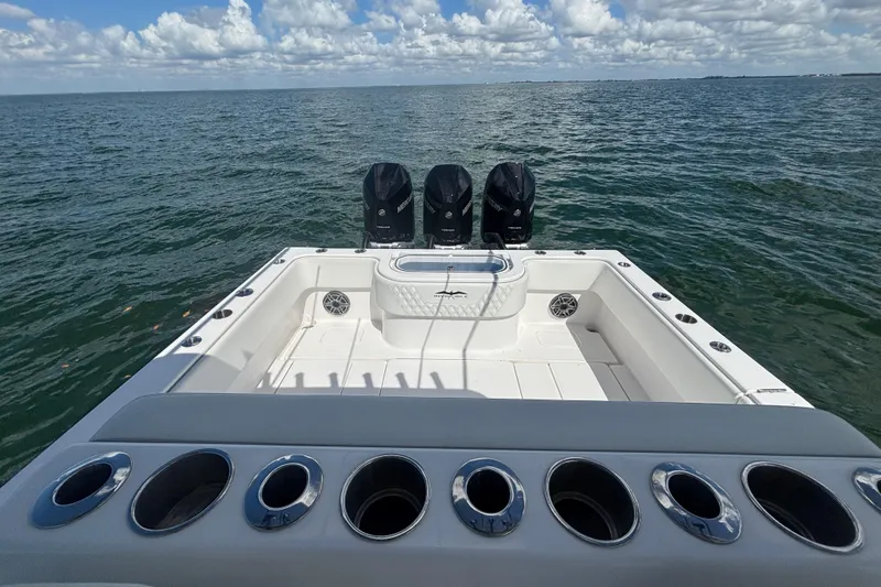Slide: The Image of 2024 Invincible 36 Open Fisherman boat with triple engines on open water. - 16