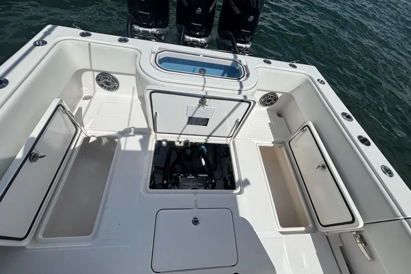 Slide: The Image of 2024 Invincible 36 Open Fisherman boat deck with storage compartments and engines. - 17
