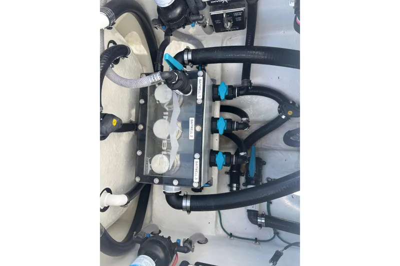 Slide: The Image of 2024 Invincible 36 Open Fisherman boat plumbing system with labeled valves and hoses. - 19