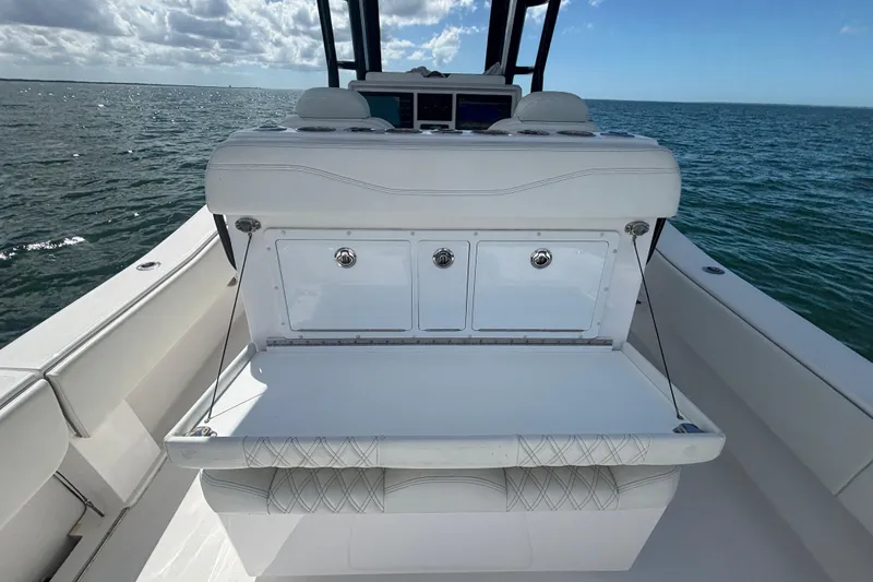 Slide: The Image of 2024 Invincible 36 Open Fisherman boat interior with seating and storage, on open water. - 23