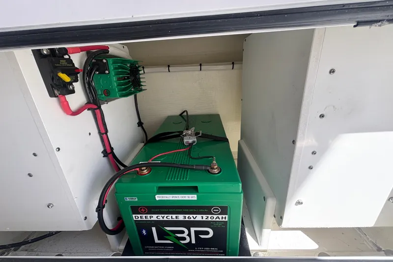 Slide: The Image of Battery compartment of 2024 Invincible 36 Open Fisherman with deep cycle battery and wiring. - 27