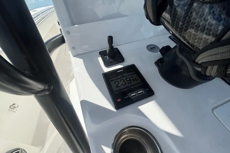 Slide: The Image of 2024 Invincible 36 Open Fisherman dashboard with Garmin display and controls. - 29