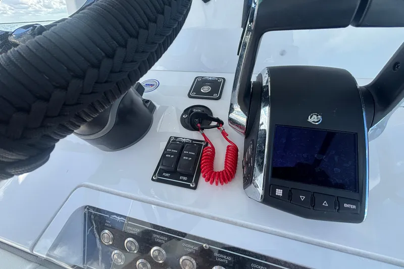 Slide: The Image of Control panel of 2024 Invincible 36 Open Fisherman boat with steering and throttle. - 30