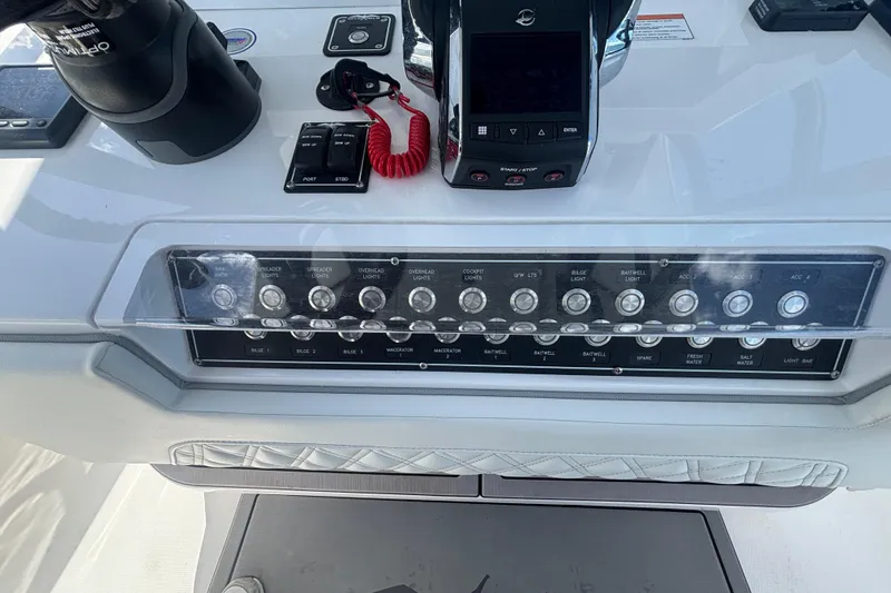 Slide: The Image of Control panel of 2024 Invincible 36 Open Fisherman boat with various switches and controls. - 31