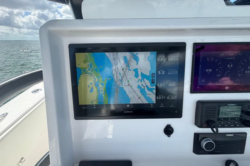Slide: The Image of 2024 Invincible 36 Open Fisherman dashboard with Garmin navigation display. - 32