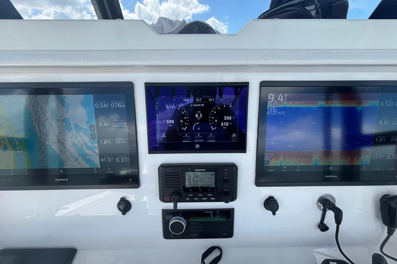 Slide: The Image of Dashboard of 2024 Invincible 36 Open Fisherman with Garmin navigation displays. - 33