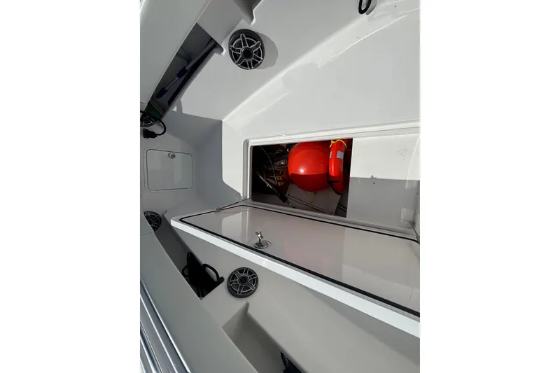 Slide: The Image of 2024 Invincible 36 Open Fisherman boat interior with storage compartment and safety equipment. - 39