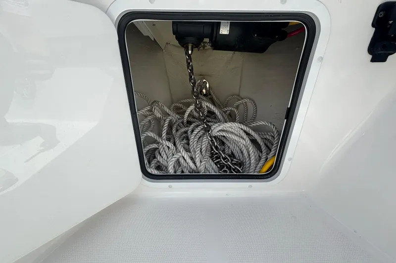 Slide: The Image of Anchor storage compartment on 2024 Invincible 36 Open Fisherman boat, featuring rope and chain. - 40