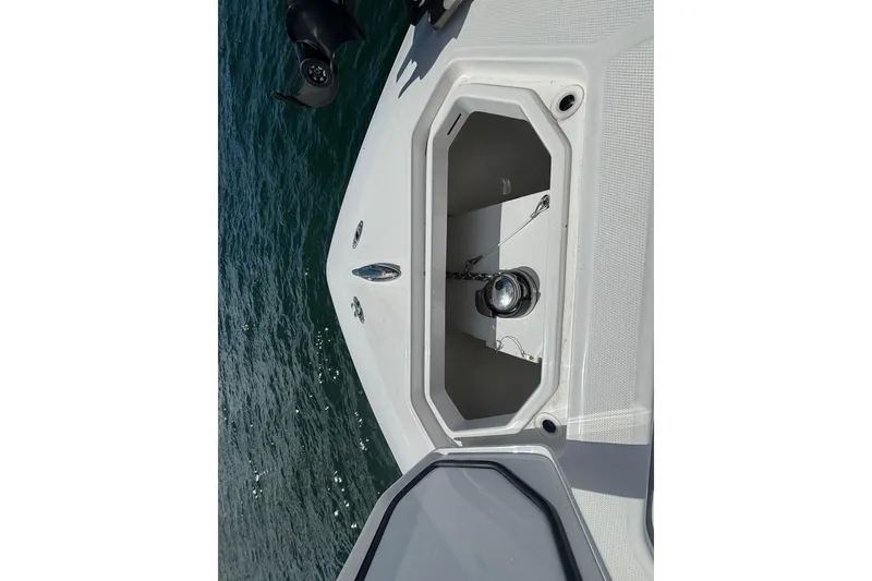 Slide: The Image of 2024 Invincible 36 Open Fisherman boat anchor compartment on calm water. - 41