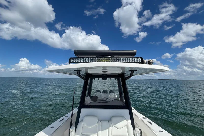 Slide: The Image of 2024 Invincible 36 Open Fisherman boat on open water under a blue sky. - 44