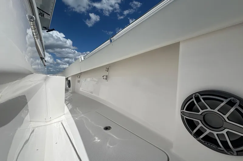 Slide: The Image of 2024 Invincible 36 Open Fisherman boat deck with speaker, under a blue sky. - 47