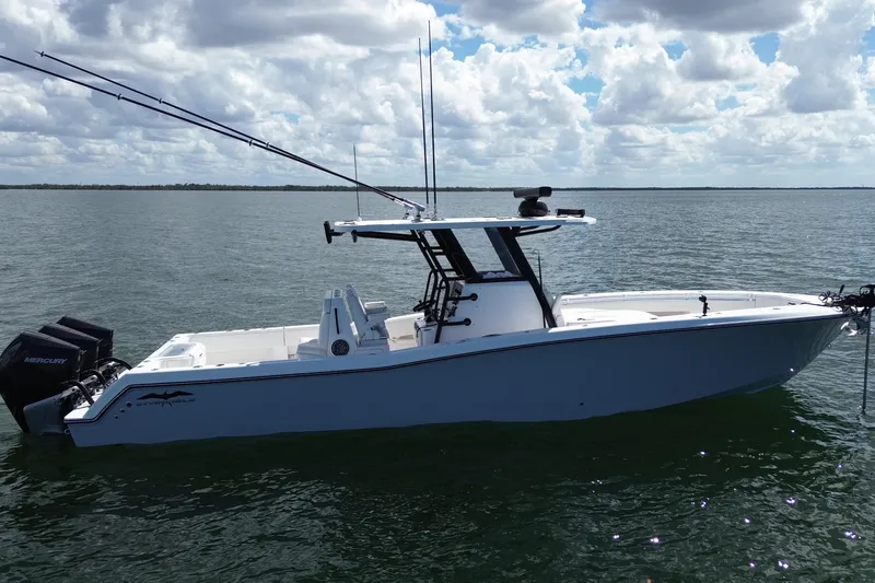 Slide: The Image of 2024 Invincible 36 Open Fisherman boat on calm water under cloudy sky. - 6