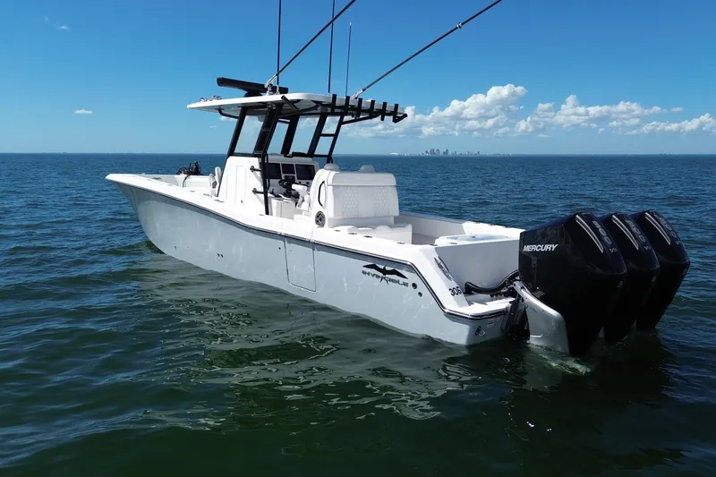 Slide: The Image of 2024 Invincible 36 Open Fisherman boat on open water, featuring triple Mercury engines. - 9