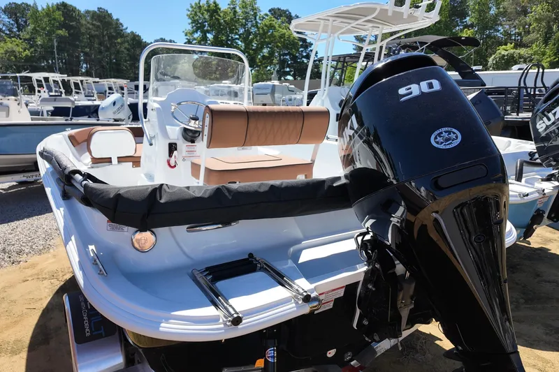 Slide: The Image of 2026 ALK2 Powerboats 18 CRS with 90 HP engine, docked outdoors. - 10