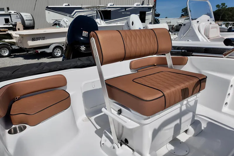 Slide: The Image of 2026 ALK2 Powerboats 18 CRS interior with brown cushioned seating and modern design. - 4