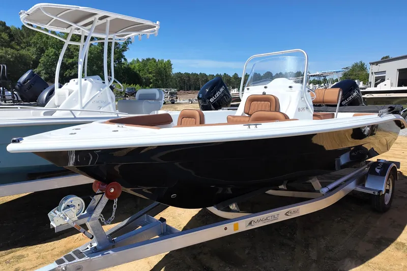 Slide: The Image of 2026 ALK2 Powerboats 18 CRS on trailer, sleek design, black hull, brown seating. - 6