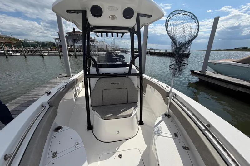 Slide: The Image of 2022 Sea Pro 219 Deep V CC boat docked at marina with fishing net. - 10